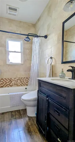 a bathroom with a sink toilet a mirror and shower