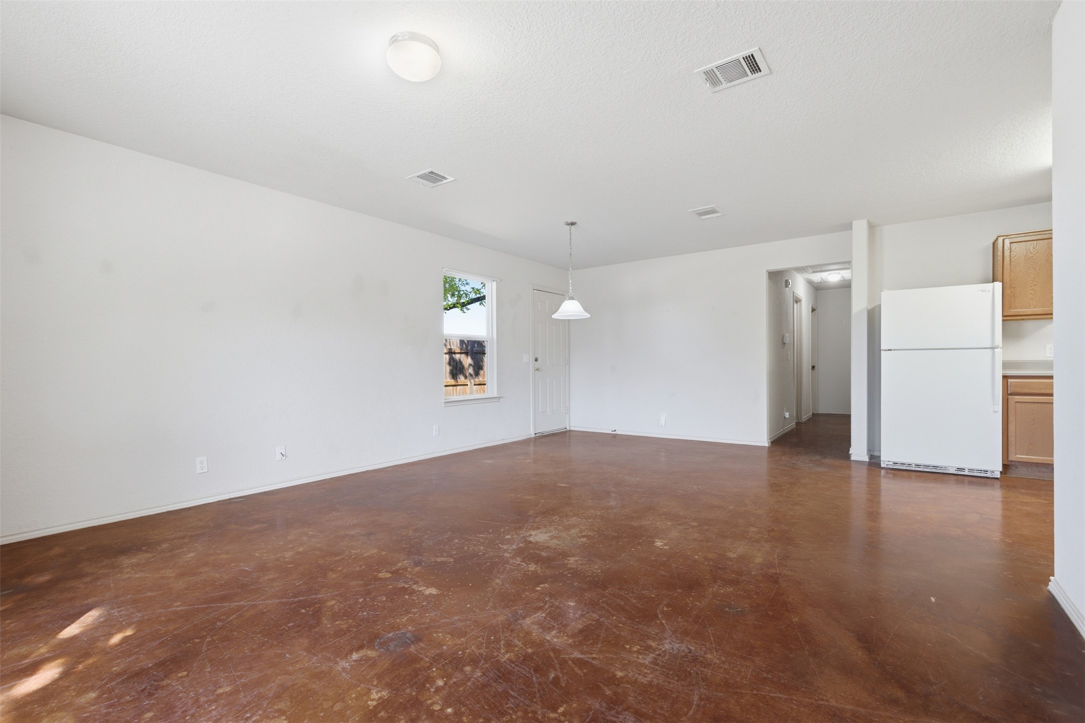 4529 Secure Lane, Unit 31 Austin, TX 78725 - Photo 10 of 38 an empty room with a empty space and a refrigerator