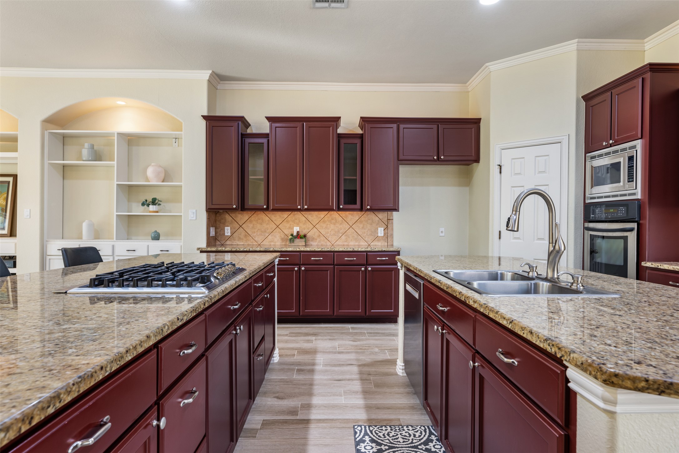 181 Whitney Run Buda, TX 78610 - Photo 15 of 40 Huge kitchen with double islands, granite countertops, glass front cabinets & stainless steel appliances.