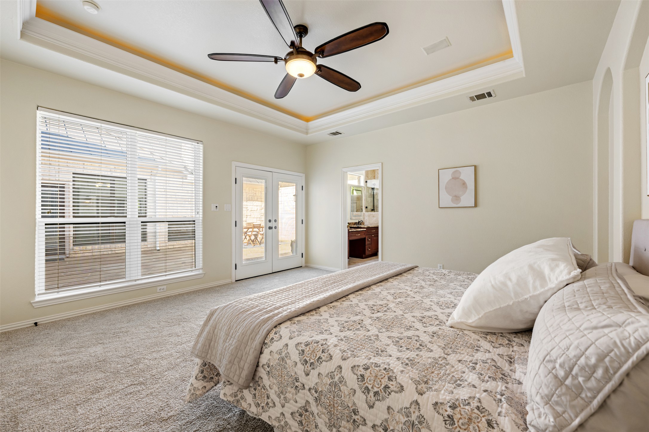 181 Whitney Run Buda, TX 78610 - Photo 21 of 40 French doors from primary bedroom lead to beautiful central courtyard.
