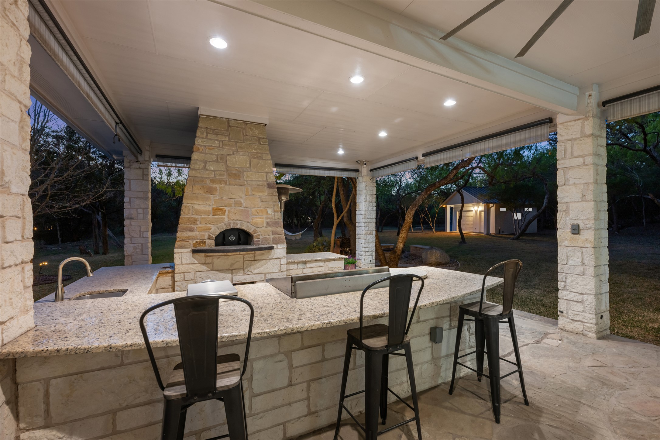 181 Whitney Run Buda, TX 78610 - Photo 2 of 40 Fabulous covered back patio with outdoor kitchen, bar & pizza oven.