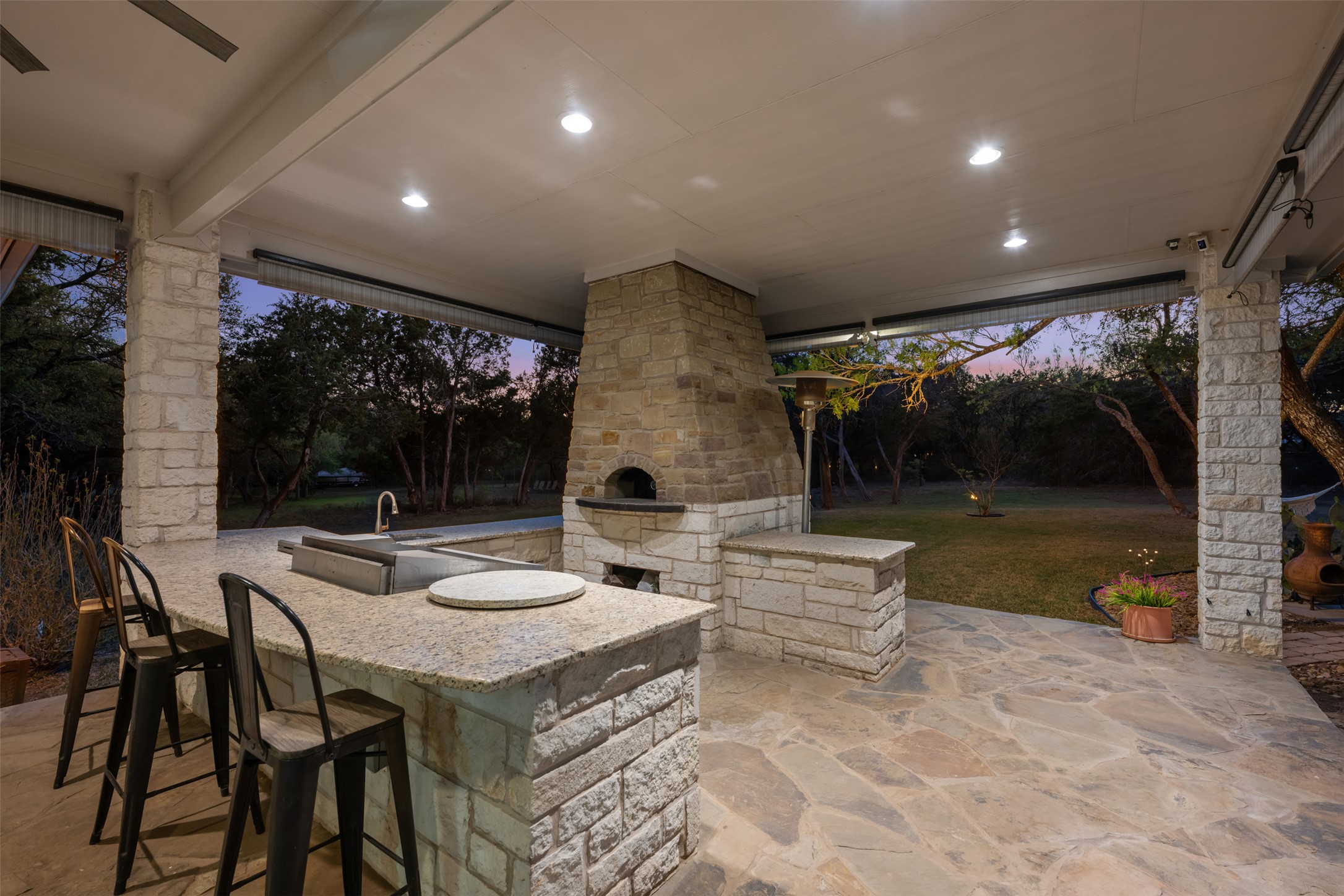 181 Whitney Run Buda, TX 78610 - Photo 30 of 40 Large covered back patio with outdoor kitchen, pizza oven & bar!