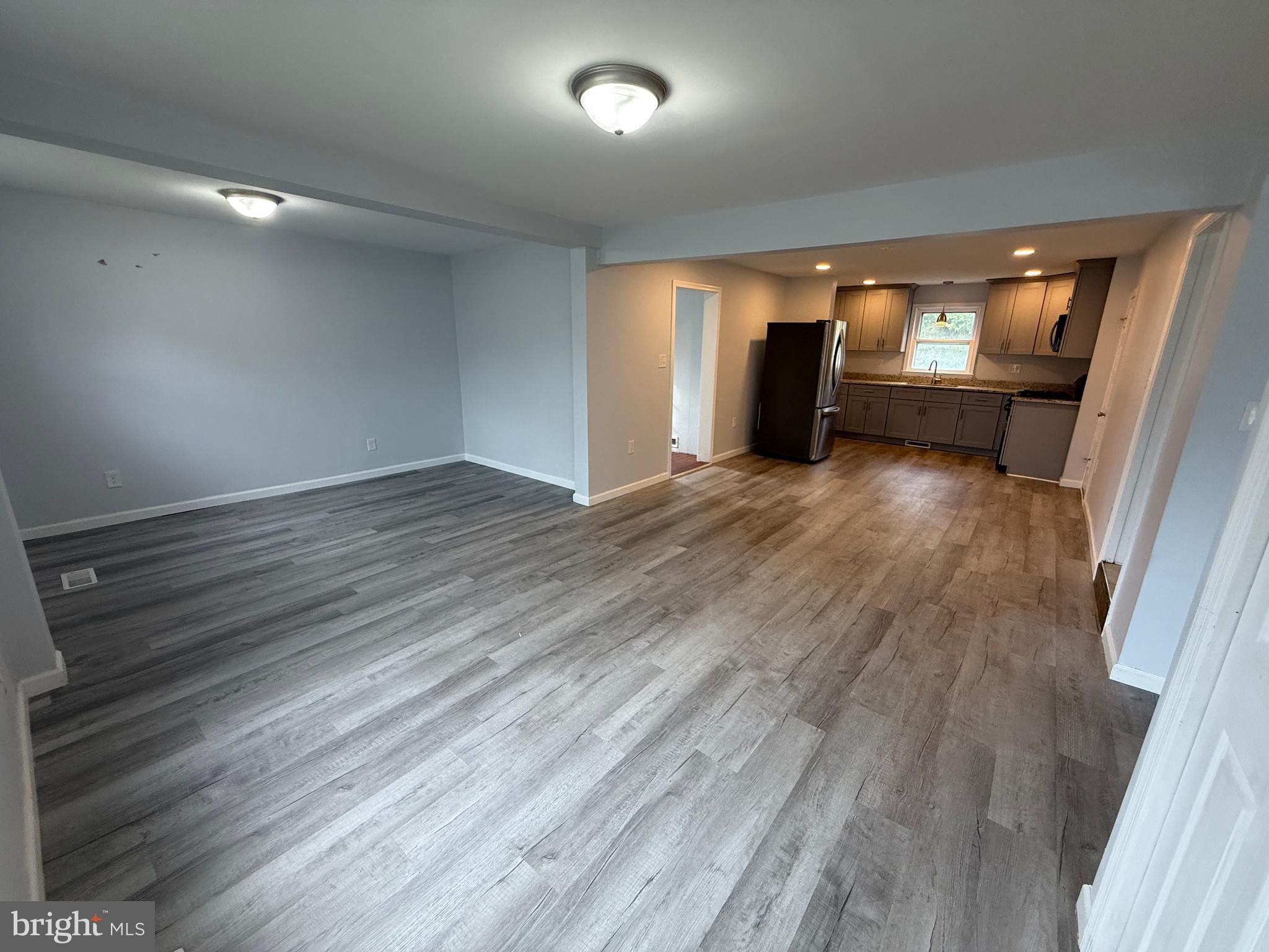 1036 South Spring Road Vineland, NJ 08361 - Photo 13 of 31 an empty room with wooden floor and windows
