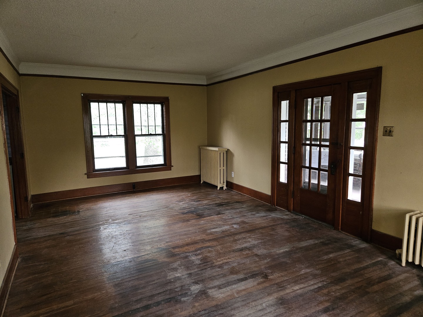 402 East 5th Street Flora, IL 62839 - Photo 13 of 29 a view of an empty room with a window and wooden floor