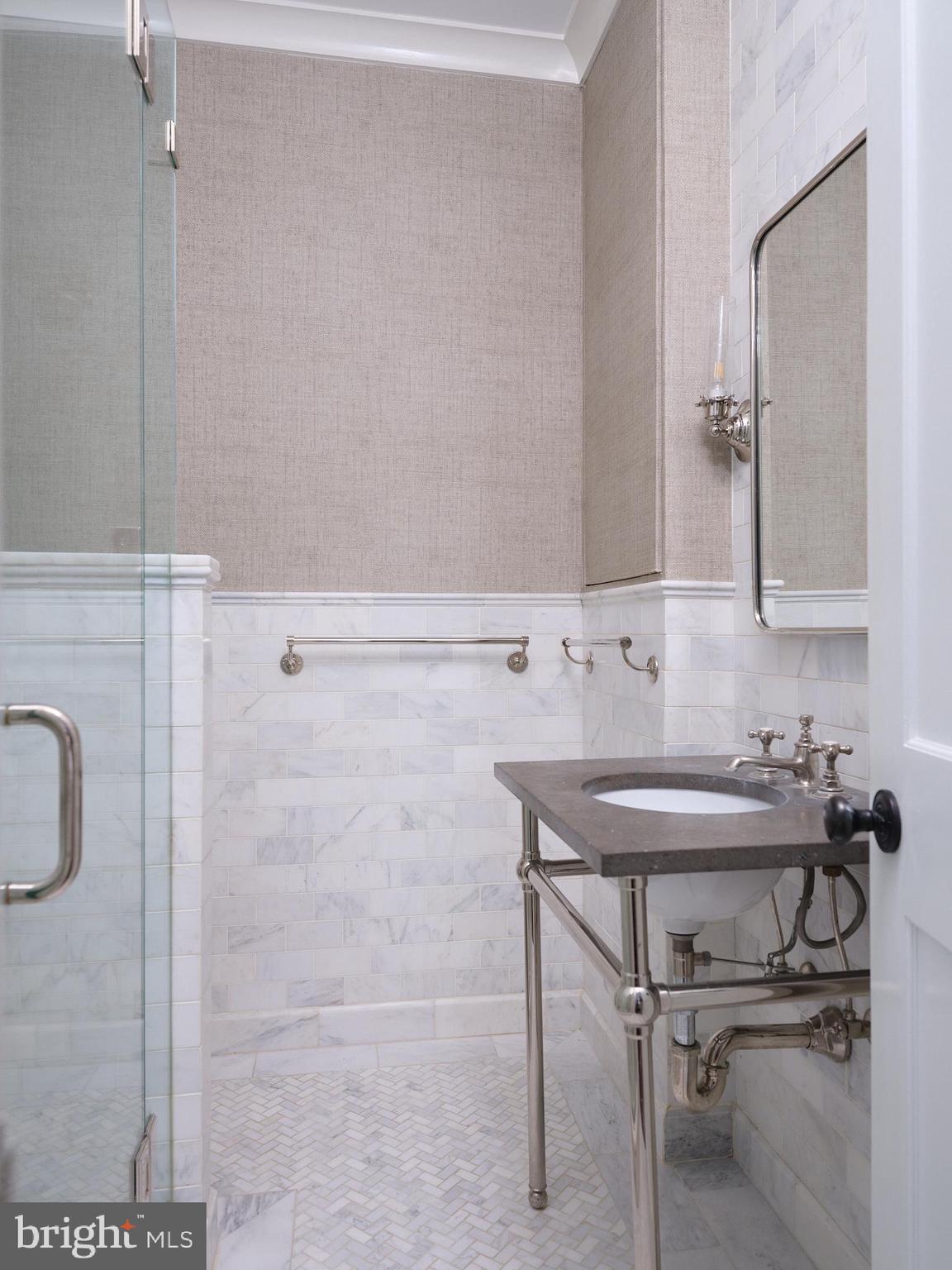 1624 Swann Street Northwest Washington, DC 20009 - Photo 11 of 16 a bathroom with a sink a toilet and a mirror