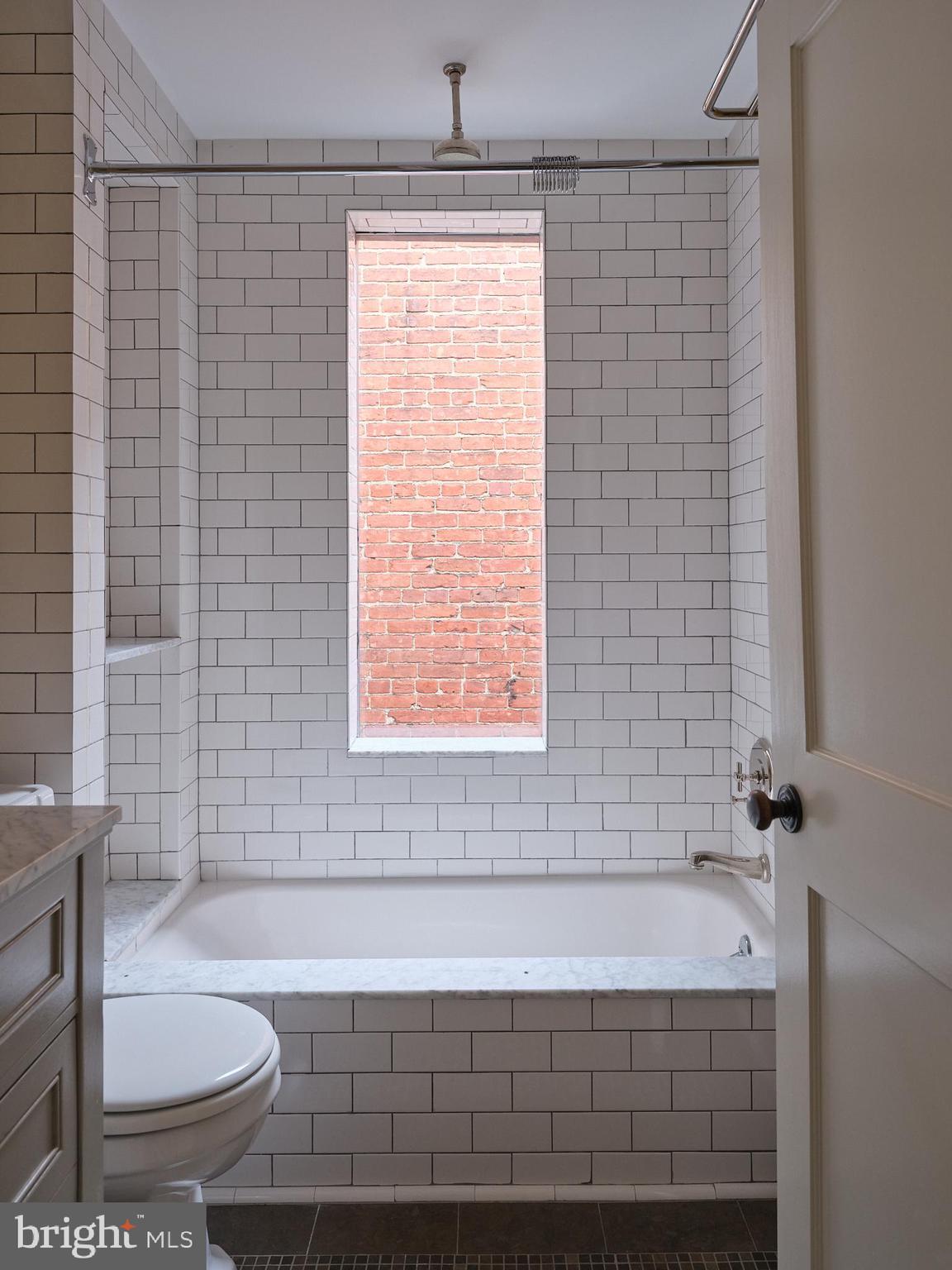 1624 Swann Street Northwest Washington, DC 20009 - Photo 14 of 16 a bathroom with a bathtub and shower
