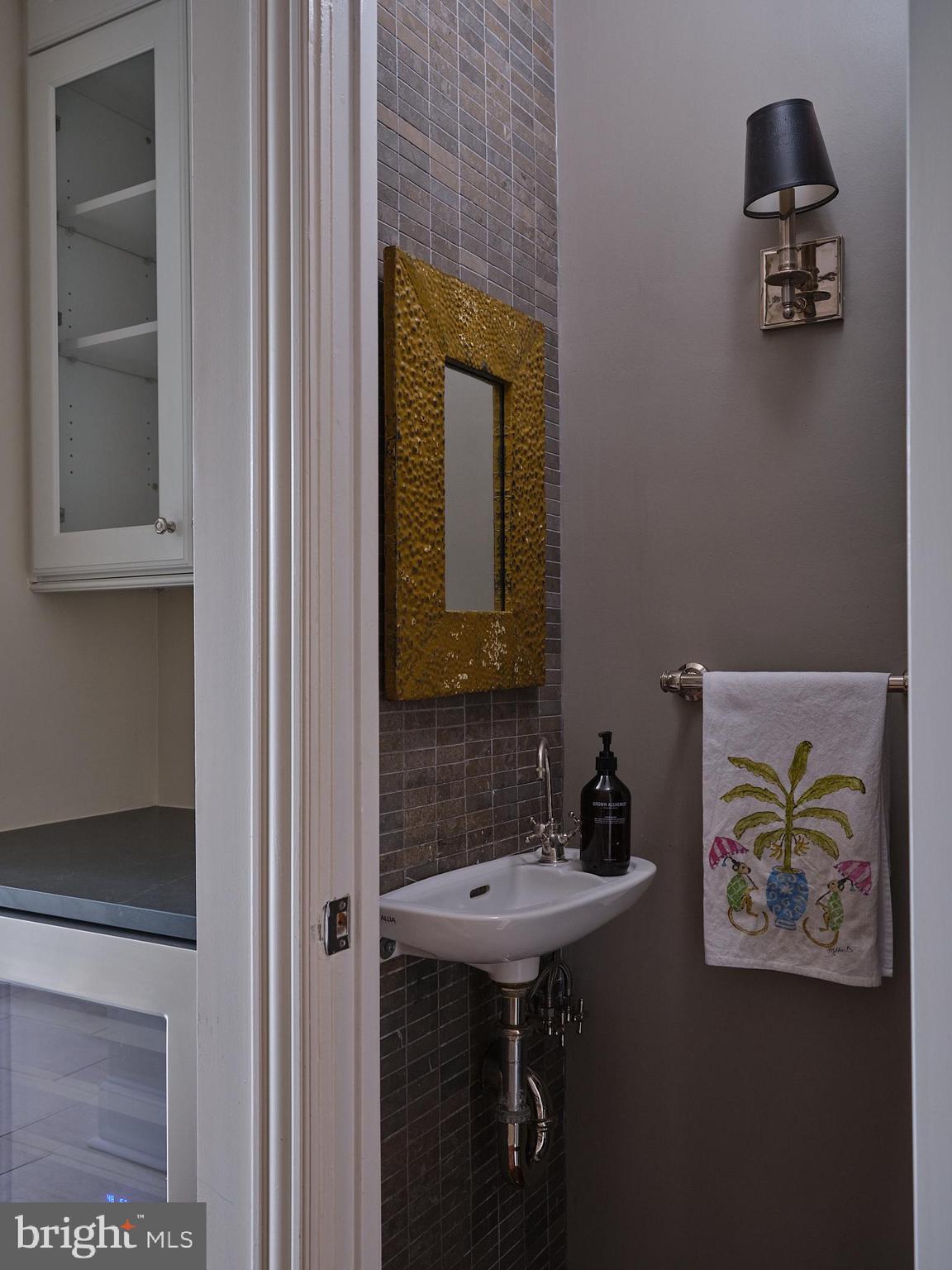 1624 Swann Street Northwest Washington, DC 20009 - Photo 9 of 16 a bathroom with a sink and a mirror