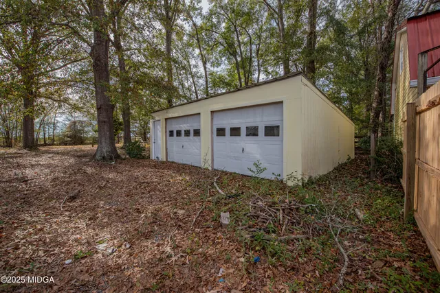 a view of a house with a yard and tree