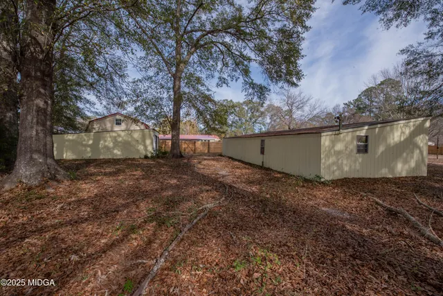 a view of backyard with large trees