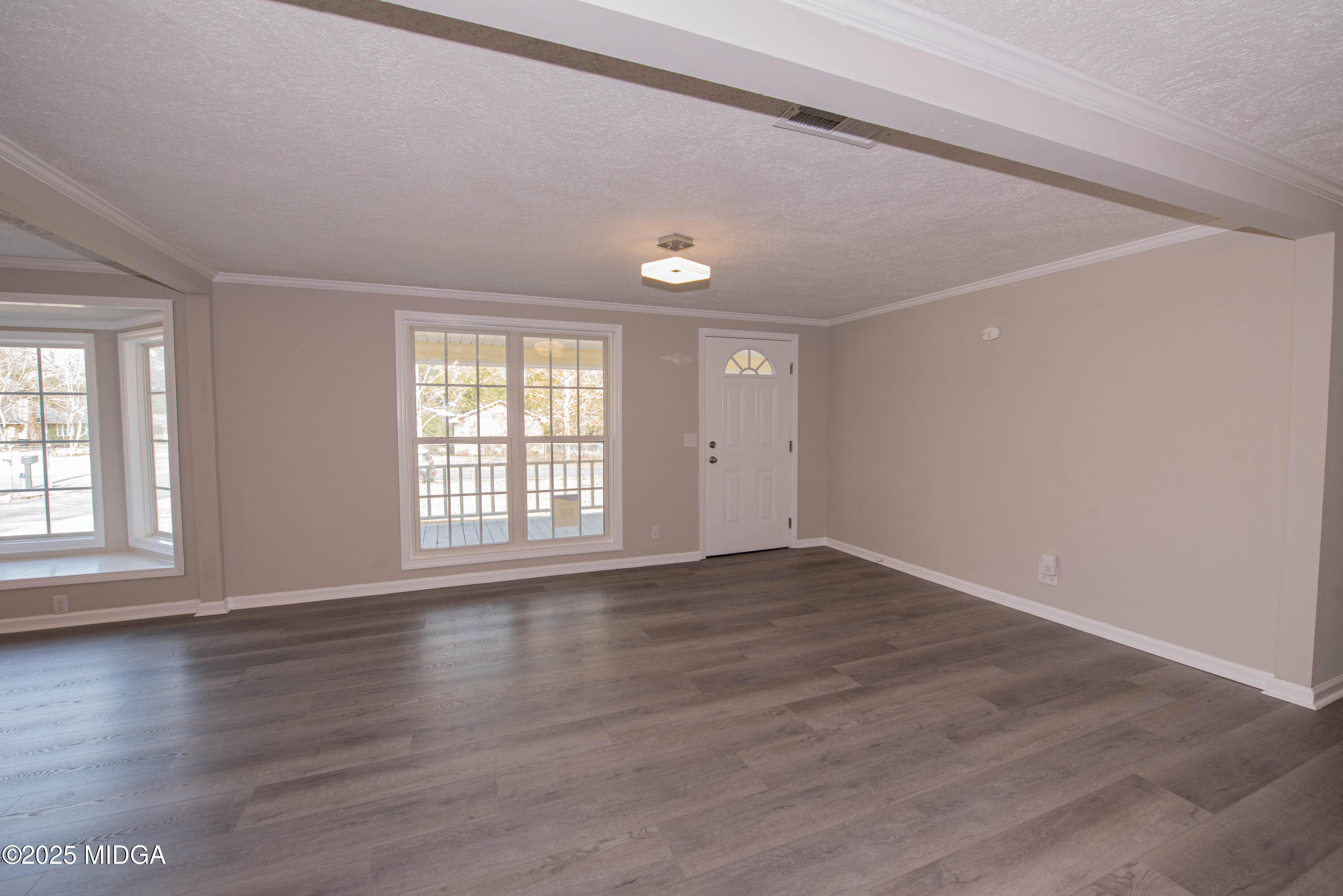 9 Friar Tuck Road Reynolds, GA 31076 - Photo 22 of 48 a view of an empty room with wooden floor and a window
