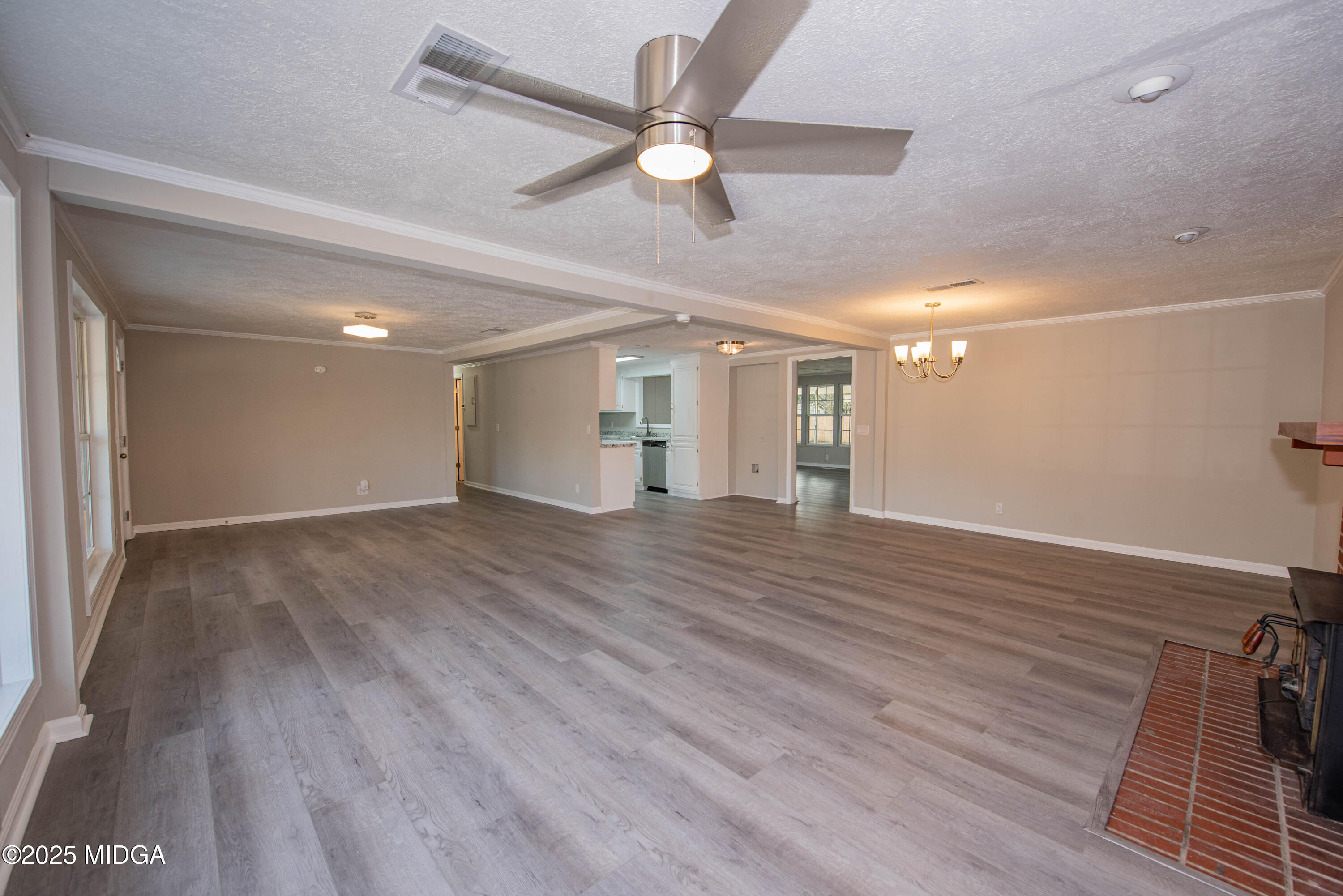 9 Friar Tuck Road Reynolds, GA 31076 - Photo 25 of 48 a view of an empty room with wooden floor and a ceiling fan