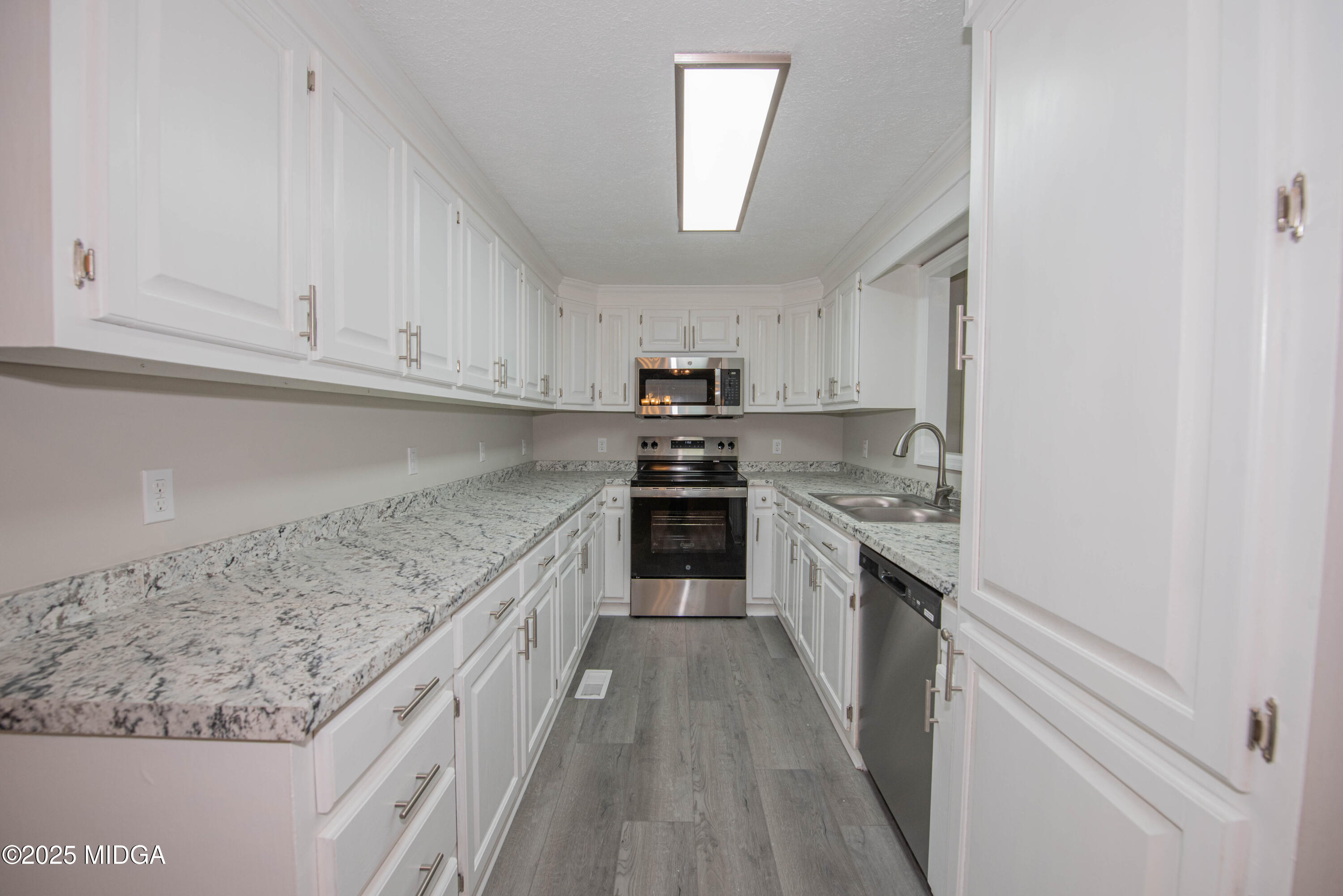 9 Friar Tuck Road Reynolds, GA 31076 - Photo 26 of 48 a kitchen with granite countertop white cabinets and stainless steel appliances