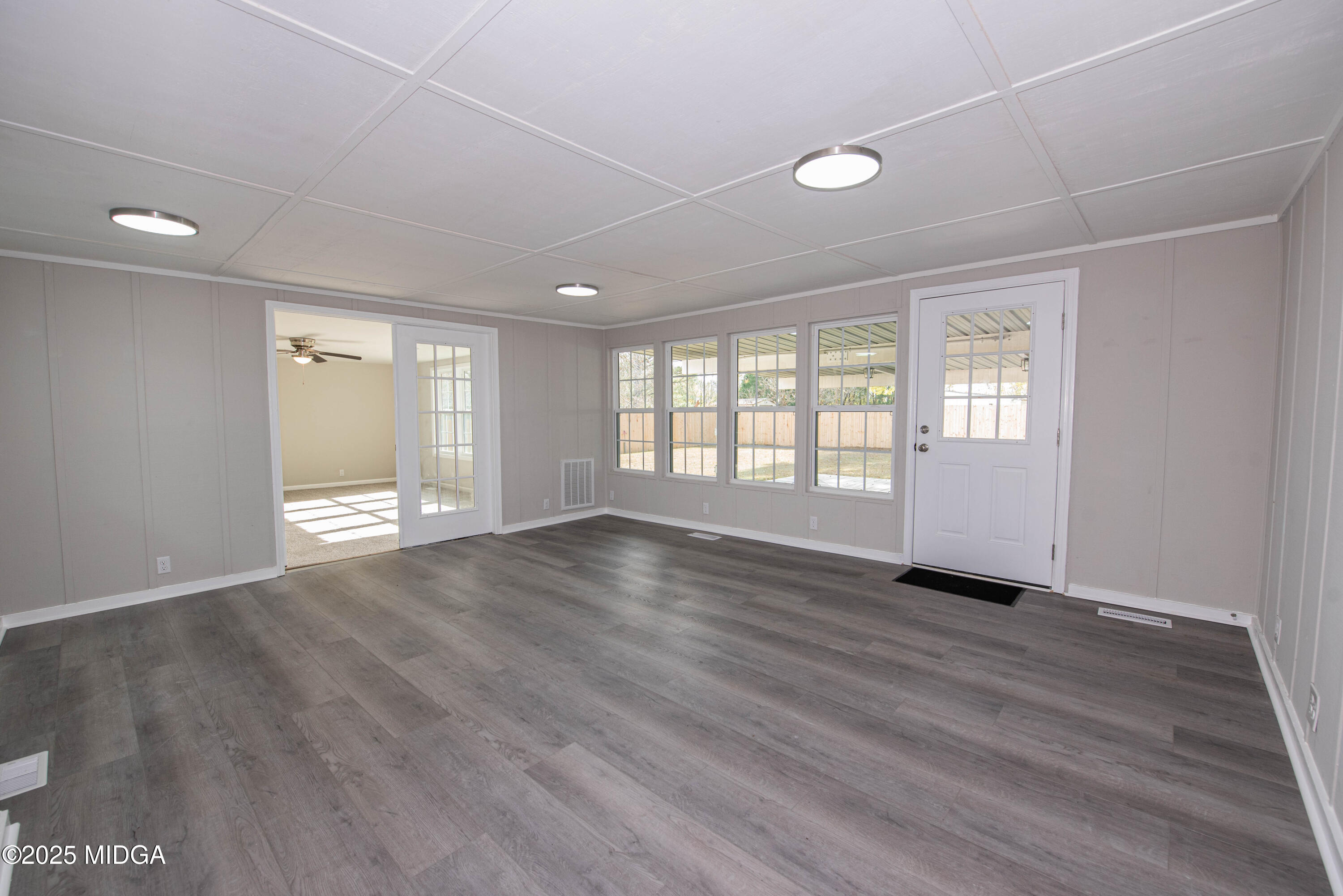 9 Friar Tuck Road Reynolds, GA 31076 - Photo 29 of 48 an empty room with wooden floor and windows