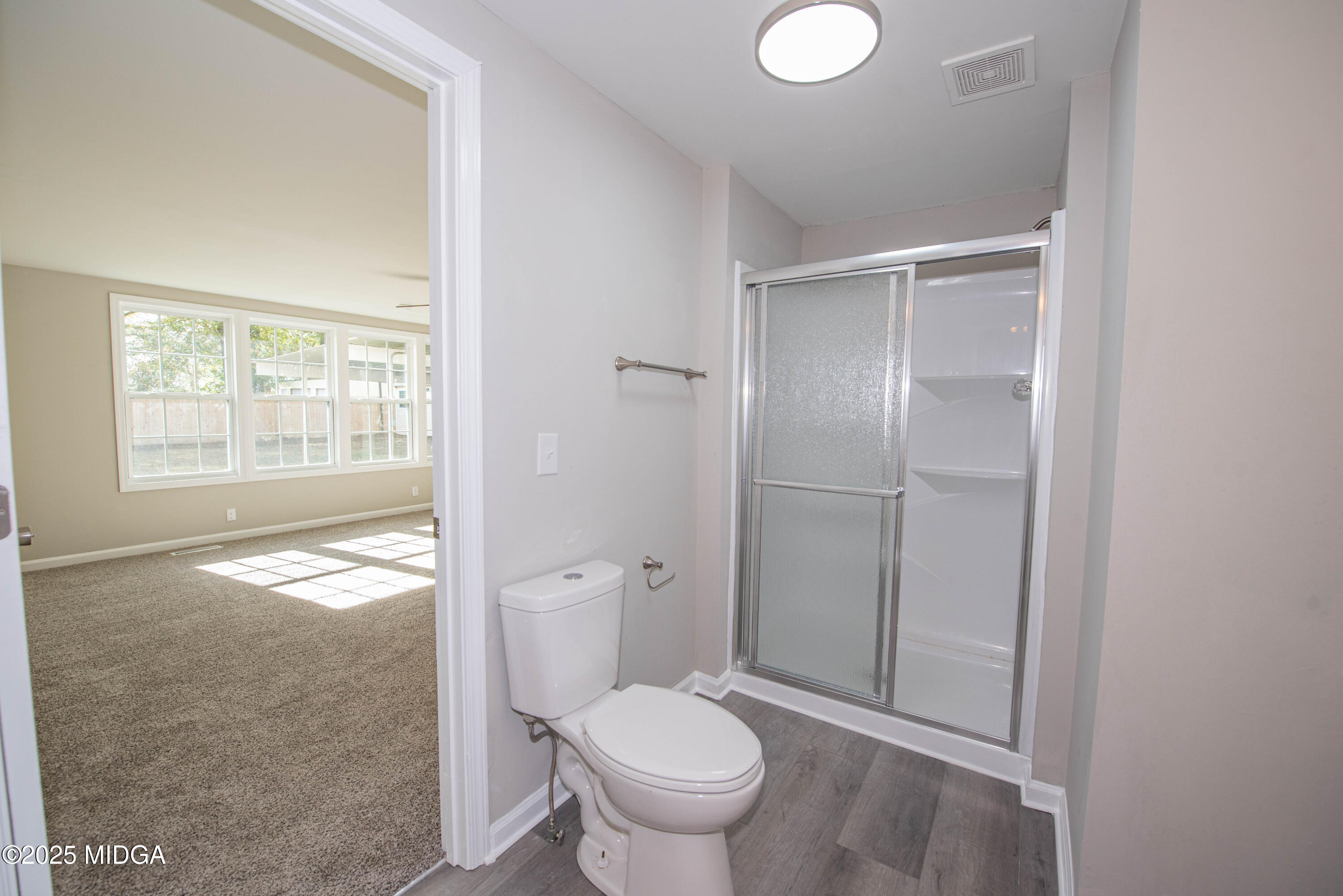 9 Friar Tuck Road Reynolds, GA 31076 - Photo 36 of 48 a bathroom with a granite countertop toilet a sink and a shower