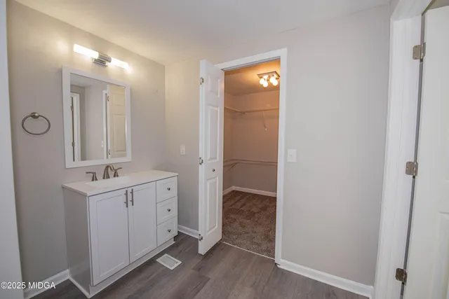 a bathroom with a sink a mirror and a shower