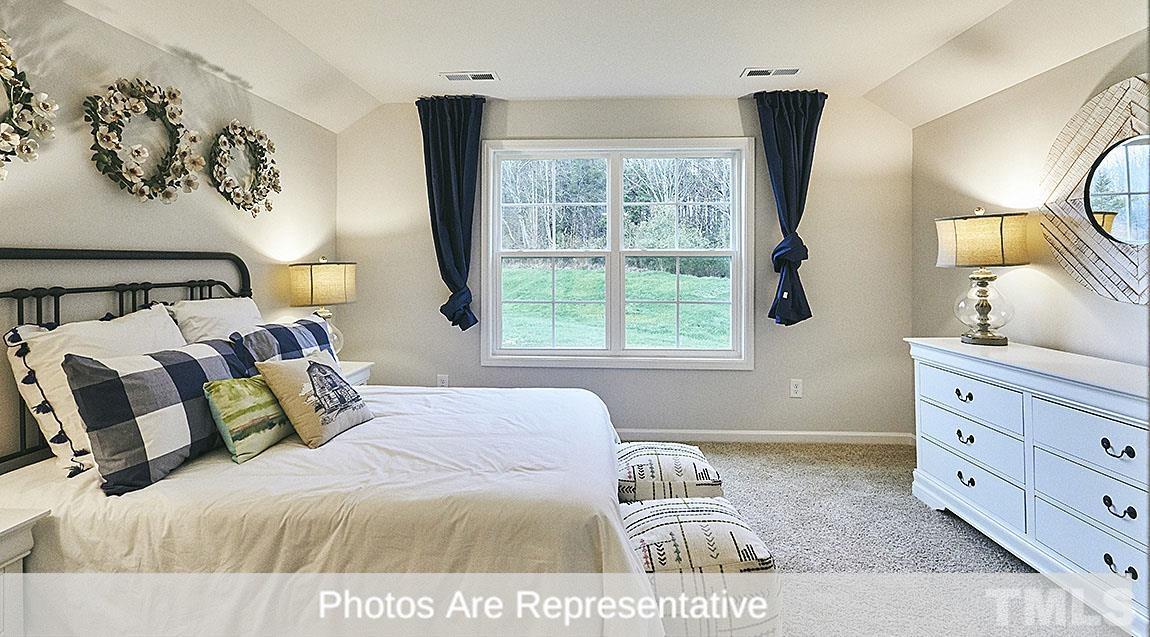 3635 Alcorn Ridge Trace Whitsett, NC 27377 - Photo 3 of 17 a bedroom with a bed and window