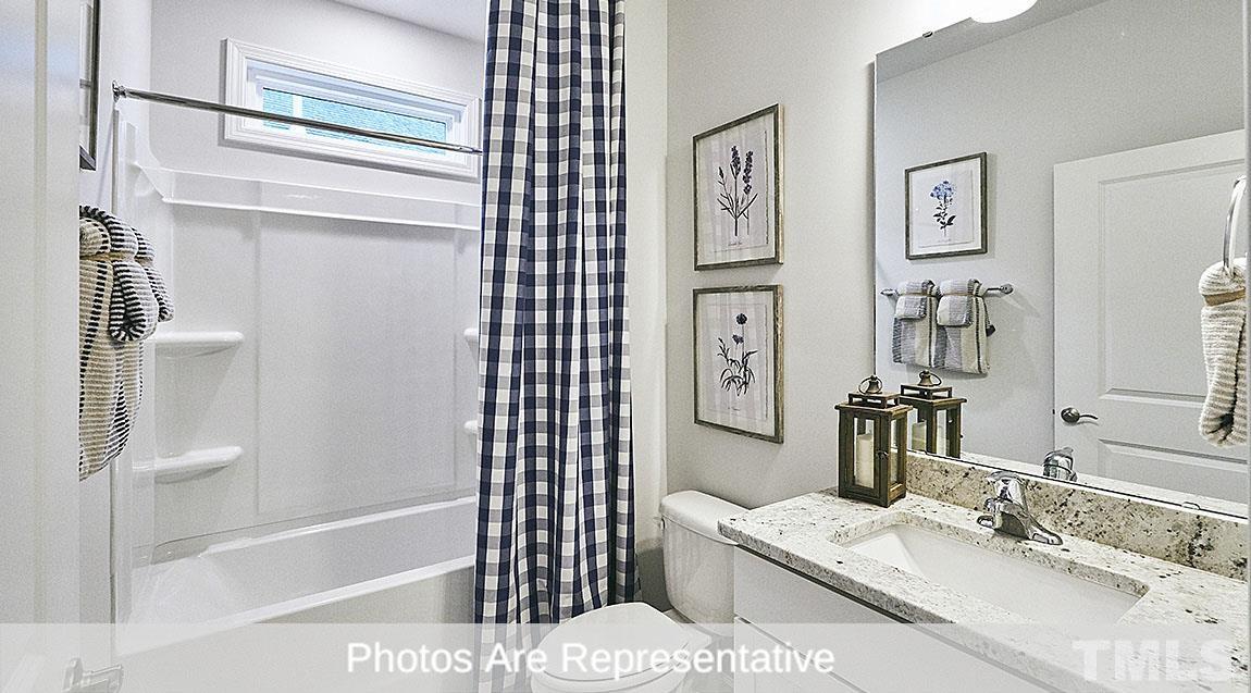 3635 Alcorn Ridge Trace Whitsett, NC 27377 - Photo 4 of 17 a bathroom with a tub sink and mirror