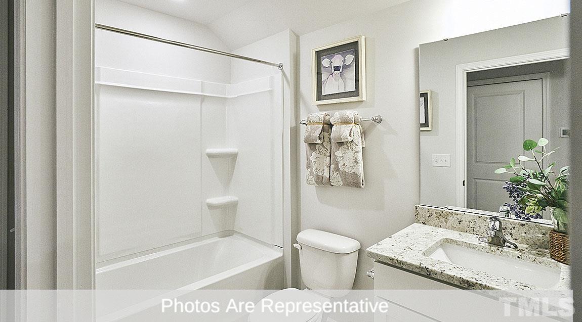 3635 Alcorn Ridge Trace Whitsett, NC 27377 - Photo 6 of 17 a bathroom with a sink a toilet and shower