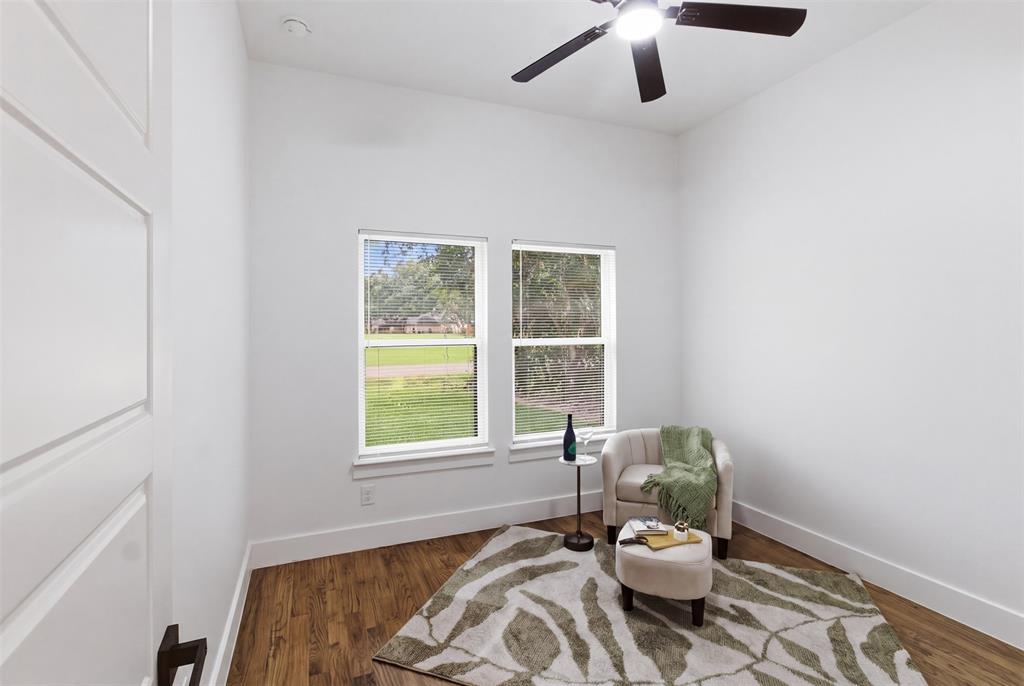 429 Waterboard Road Trinidad, TX 75163 - Photo 16 of 25 Room featuring wood-finish flooring, white baseboards, and two large windows
