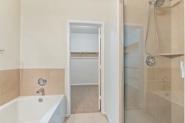 a bathroom with a bathtub and shower
