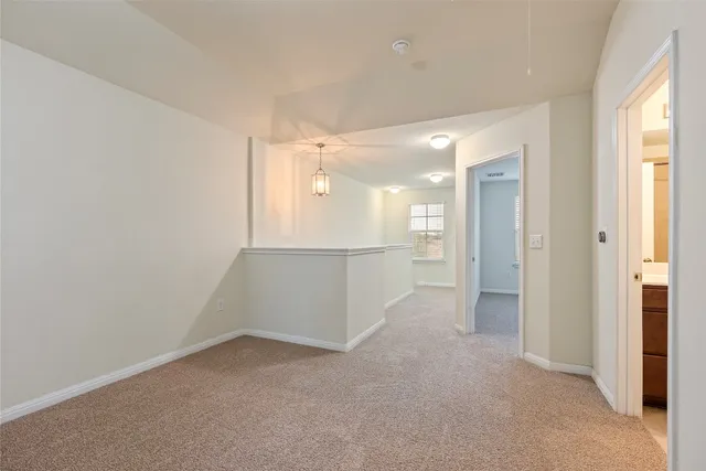 an empty room with a bathroom and a sink
