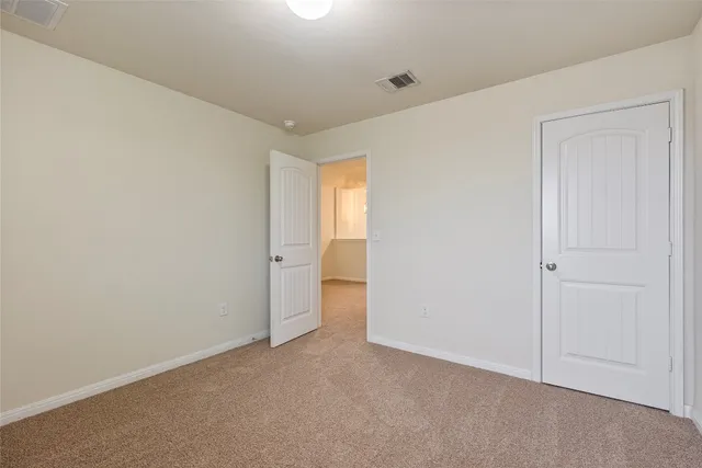 a view of an empty room and a window