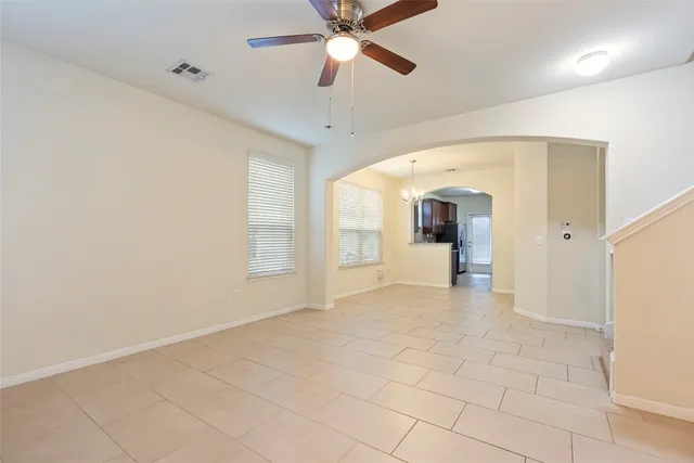 a view of a livingroom with a ceiling fan and window