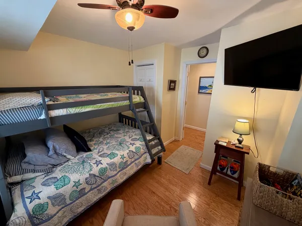 a bedroom with bed and flat screen tv