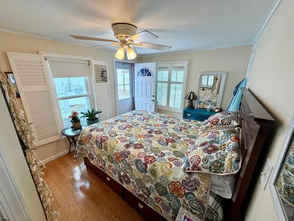 a bedroom with a bed mirror and a window