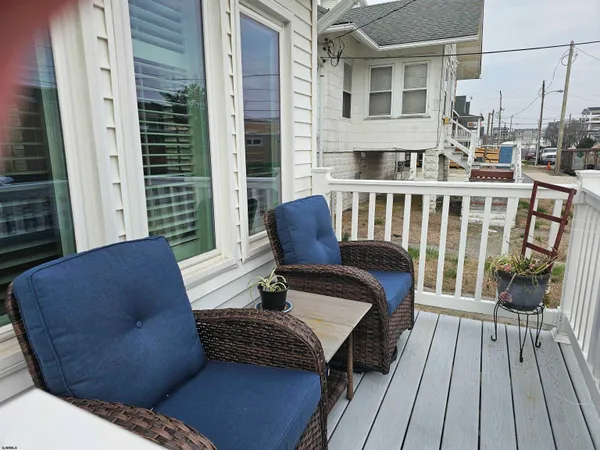 a balcony view with a couch and wooden floor
