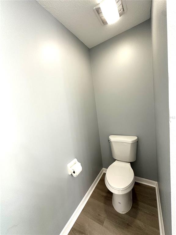 9706 Southwest 92nd Place Road Ocala, FL 34481 - Photo 18 of 82 a white toilet sitting next to a white cabinet