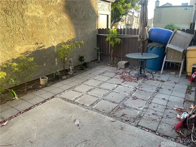 a backyard of a house with table and chairs