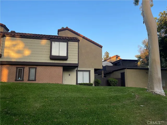 a front view of house with a garden