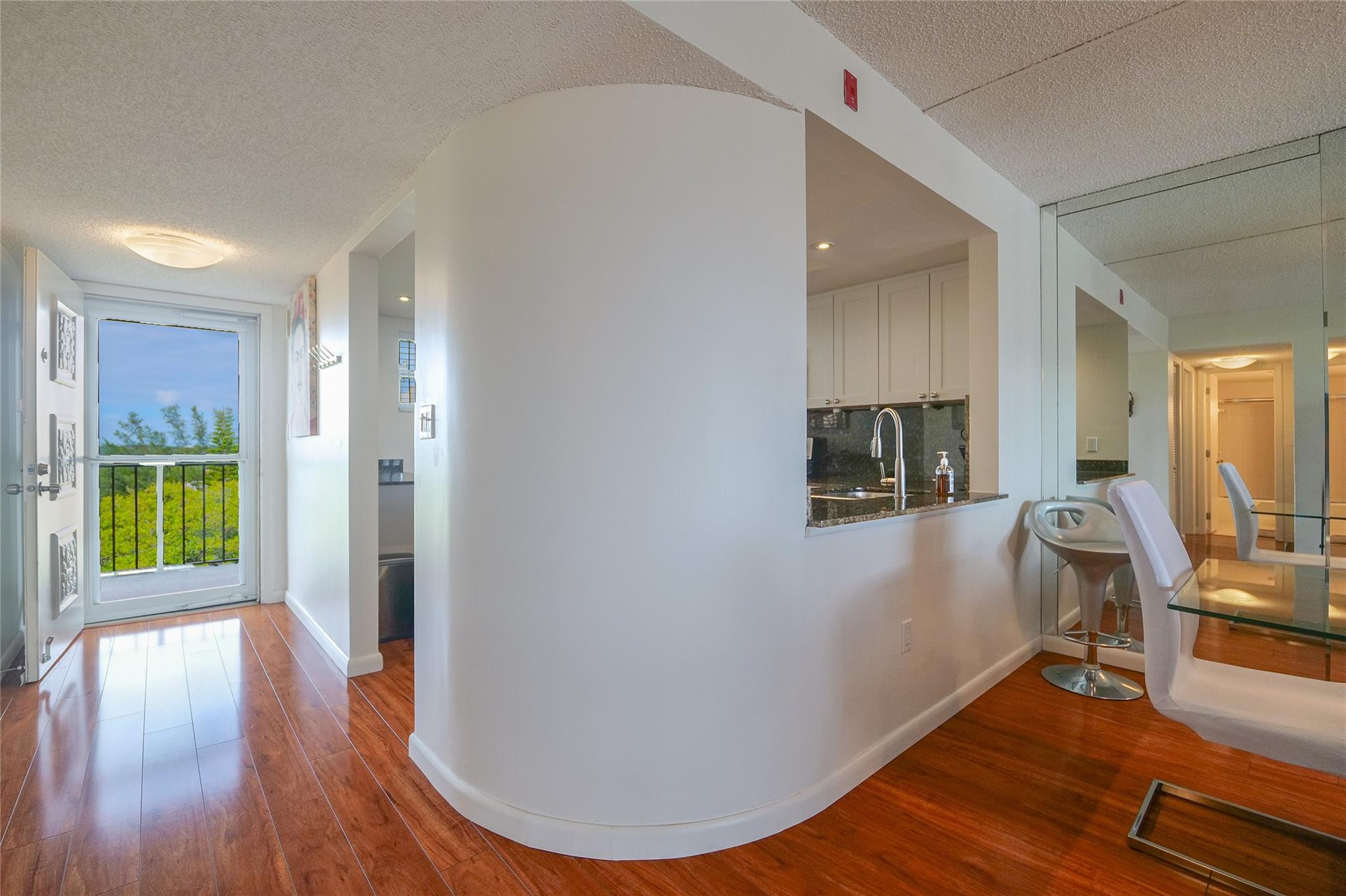 3930 Inverrary Boulevard, Unit 703D Lauderhill, FL 33319 - Photo 12 of 72 a view of a hallway with wooden floor and a living room