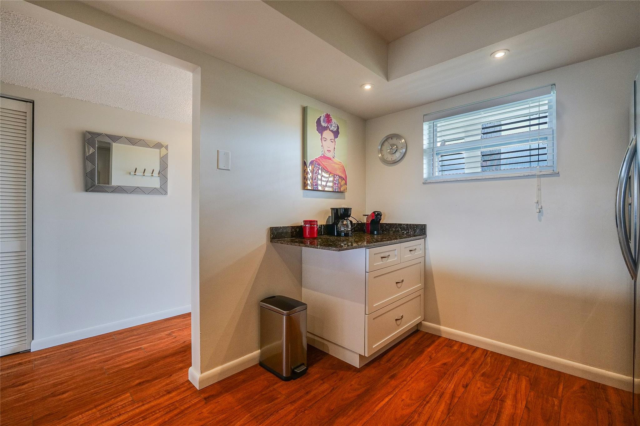 3930 Inverrary Boulevard, Unit 703D Lauderhill, FL 33319 - Photo 19 of 72 a room with wooden floor and white walls