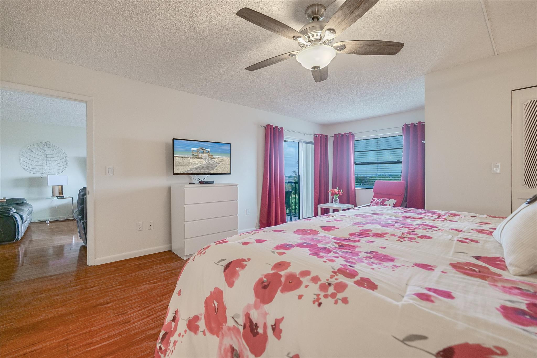 3930 Inverrary Boulevard, Unit 703D Lauderhill, FL 33319 - Photo 26 of 72 a bedroom with a large bed and a chandelier