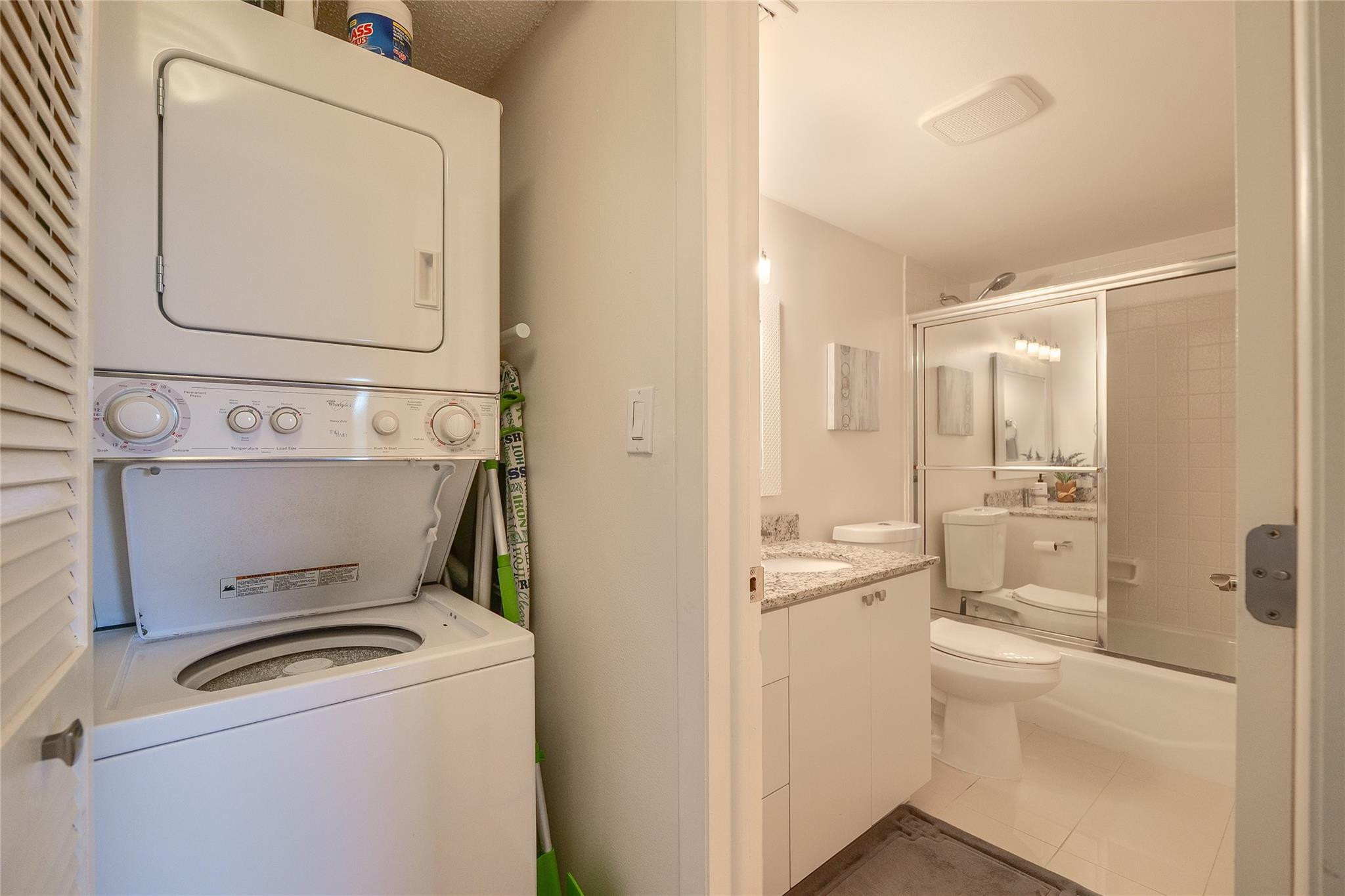 3930 Inverrary Boulevard, Unit 703D Lauderhill, FL 33319 - Photo 39 of 72 a bathroom with a toilet sink and a mirror