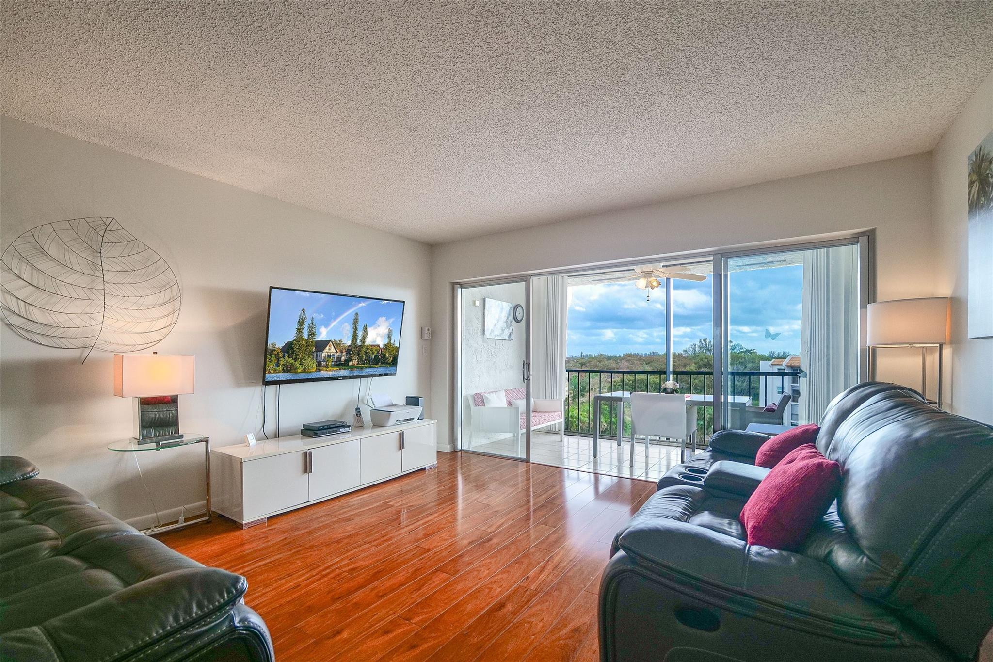3930 Inverrary Boulevard, Unit 703D Lauderhill, FL 33319 - Photo 4 of 72 a living room with furniture and a flat screen tv