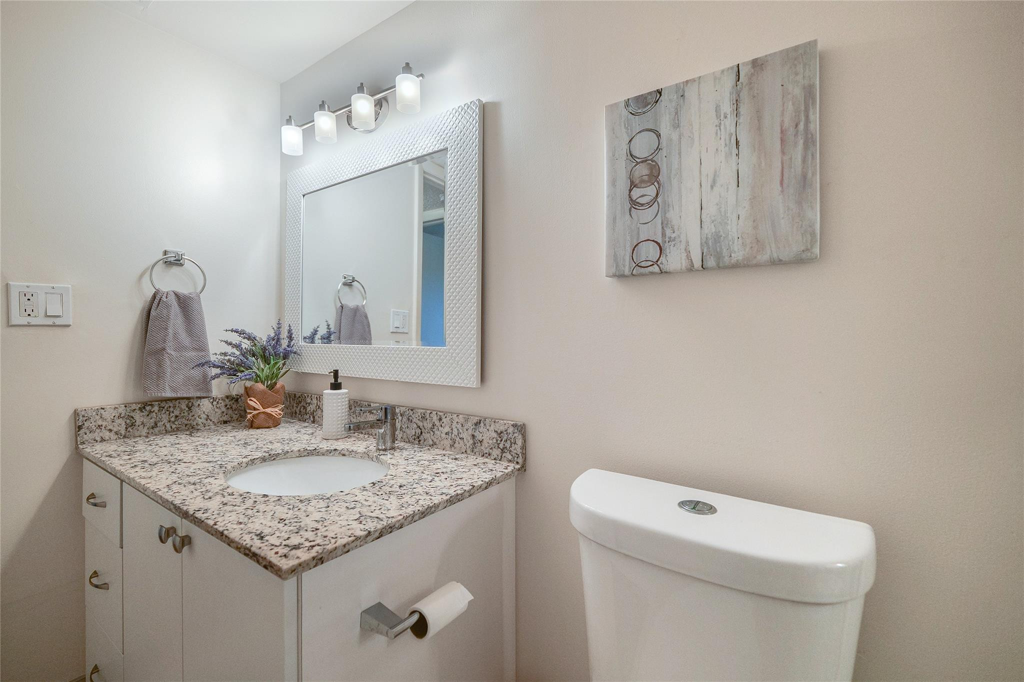 3930 Inverrary Boulevard, Unit 703D Lauderhill, FL 33319 - Photo 41 of 72 a bathroom with a granite countertop sink and a toilet