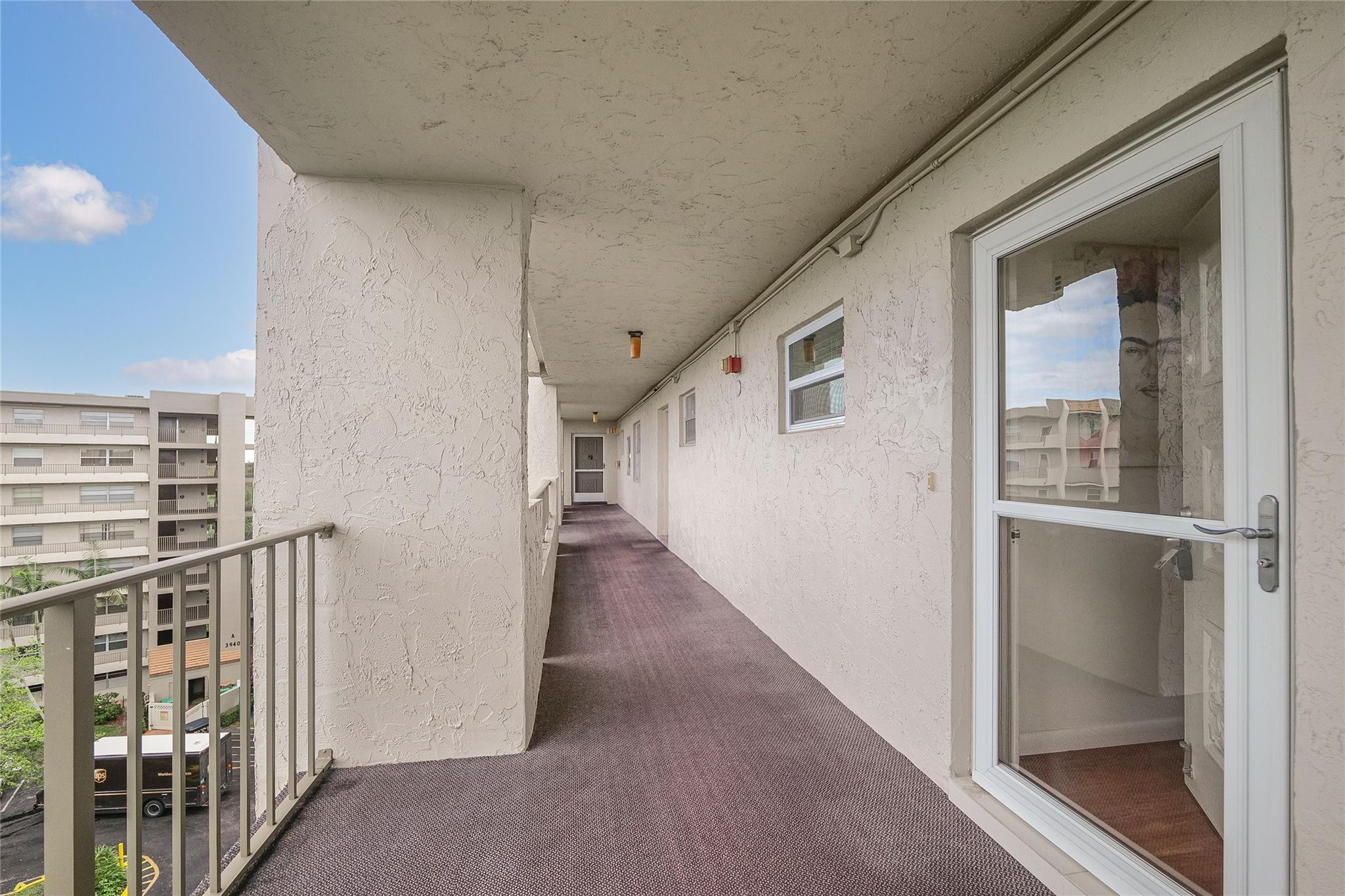 3930 Inverrary Boulevard, Unit 703D Lauderhill, FL 33319 - Photo 42 of 72 a view of a hallway with wooden floor and entryway