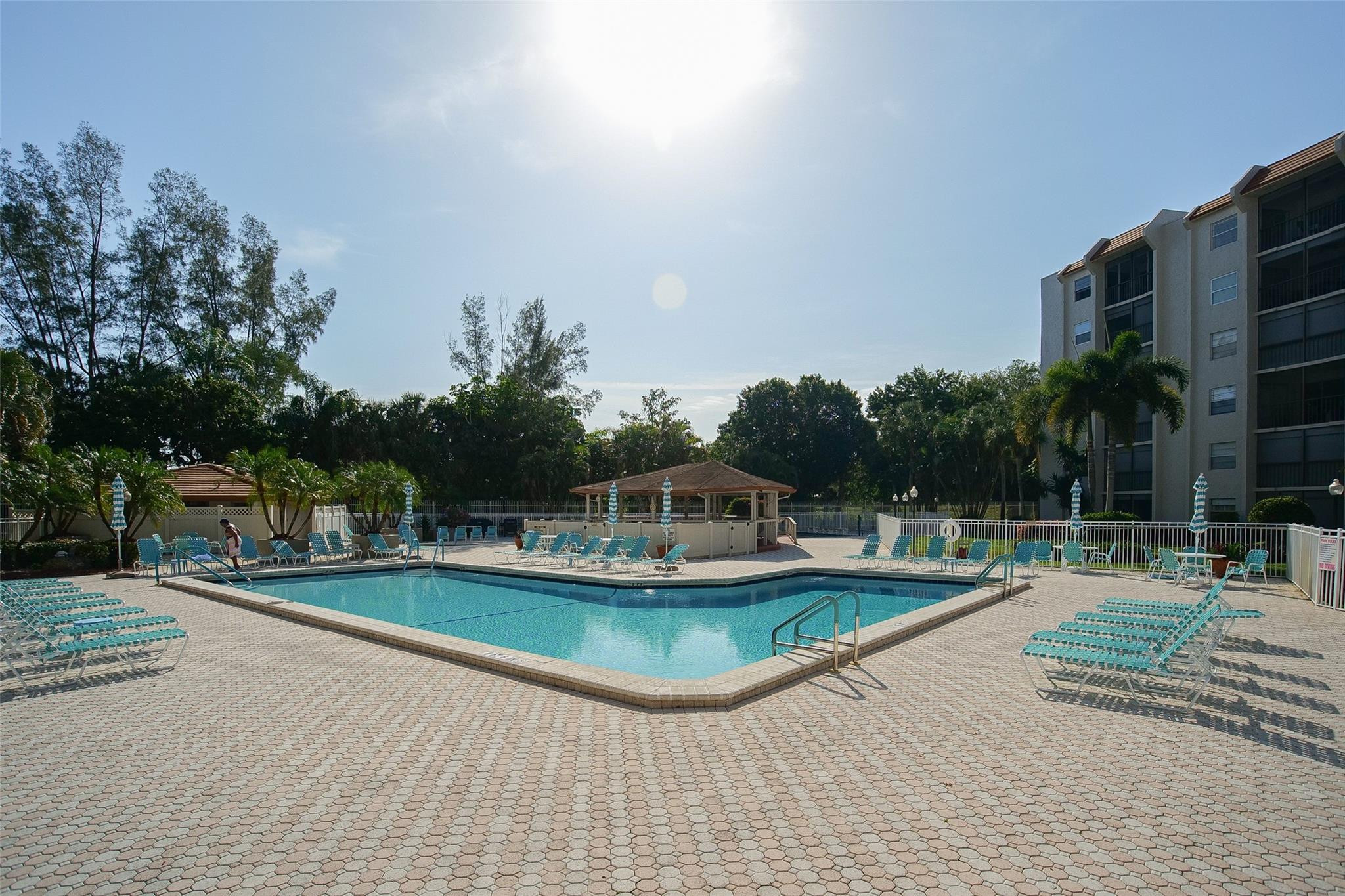 3930 Inverrary Boulevard, Unit 703D Lauderhill, FL 33319 - Photo 54 of 72 a view of a swimming pool with lounge chair