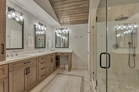 a bathroom with a double vanity sink shower and a mirror