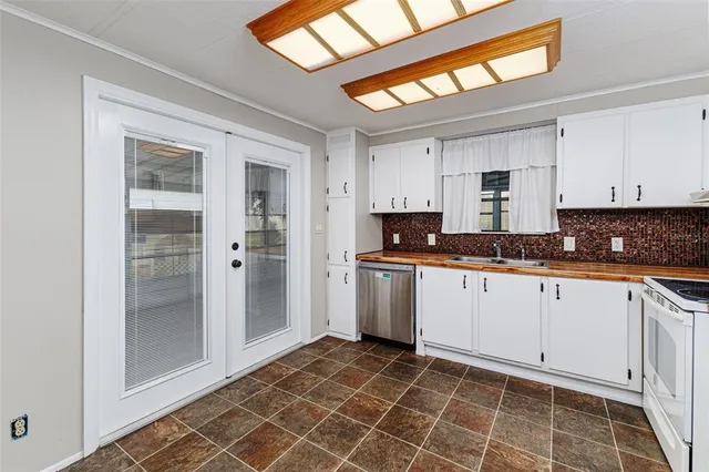 a kitchen with granite countertop a stove a sink and a cabinets