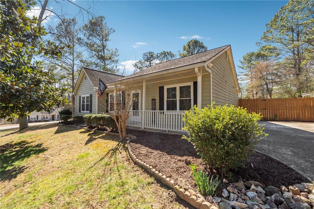 1128 Cousins Road Woodstock, GA 30188 - Photo 1 of 1 a view of a house with a yard and sitting area