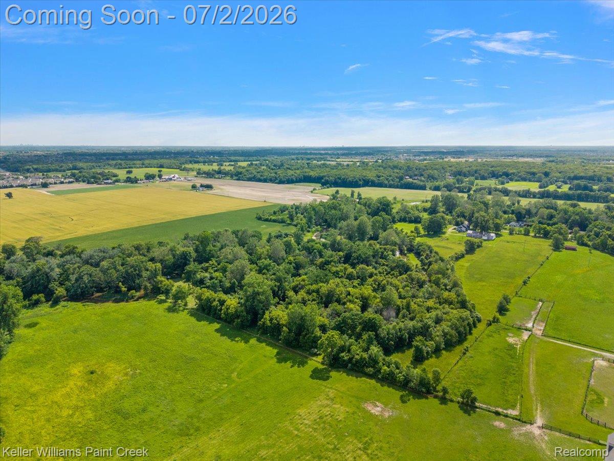 54230 Card Road Macomb, MI 48042 - Photo 24 of 73 Expansive rural landscape featuring a mix of open fields, wooded areas, and agricultural land