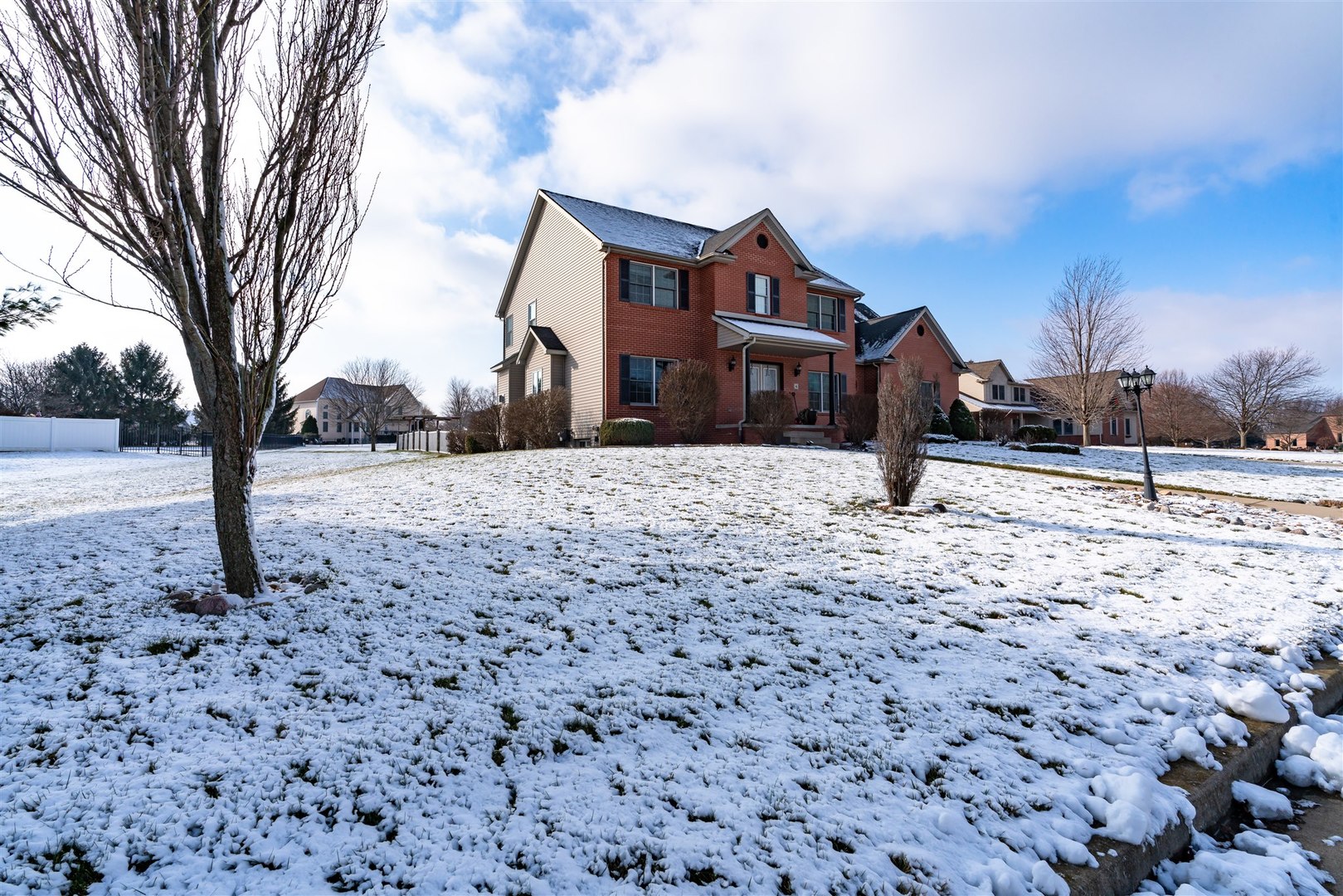 4 Cloverhill Circle Bloomington, IL 61705 - Photo 2 of 63 a front view of a house with a yard covered in snow