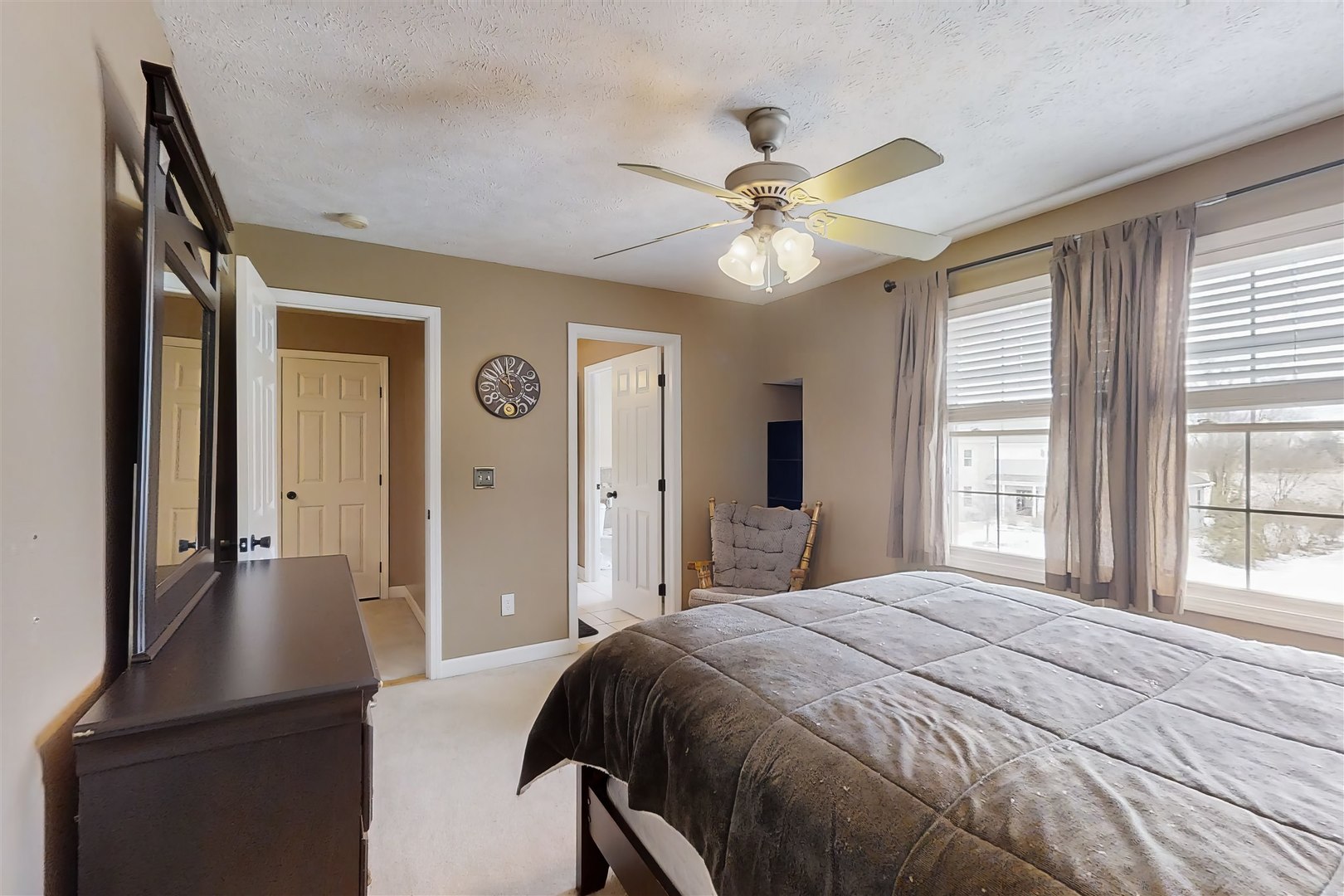 4 Cloverhill Circle Bloomington, IL 61705 - Photo 44 of 63 a bedroom with a large bed and a chandelier