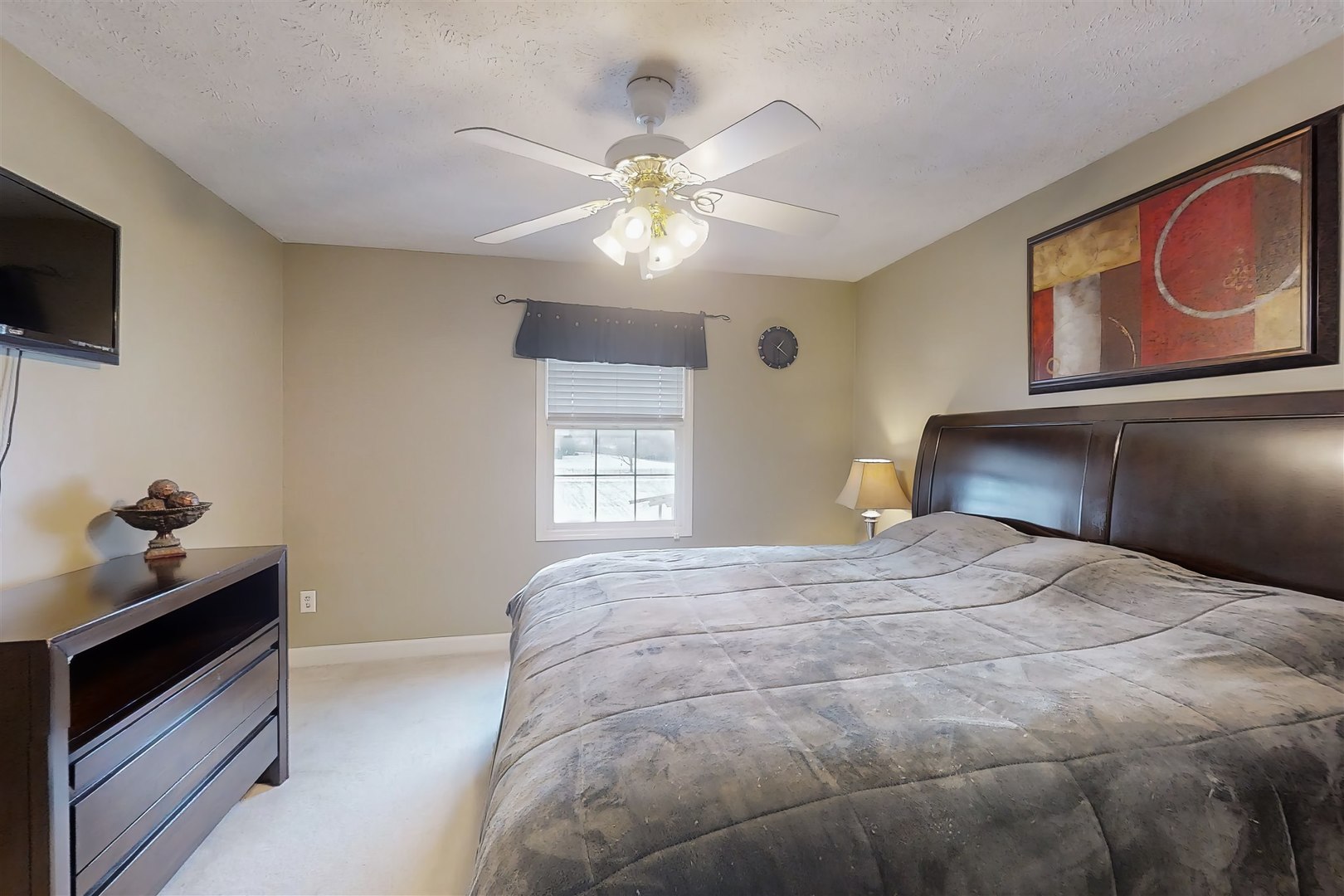 4 Cloverhill Circle Bloomington, IL 61705 - Photo 48 of 63 a bedroom with a bed and a flat tv screen on a dresser