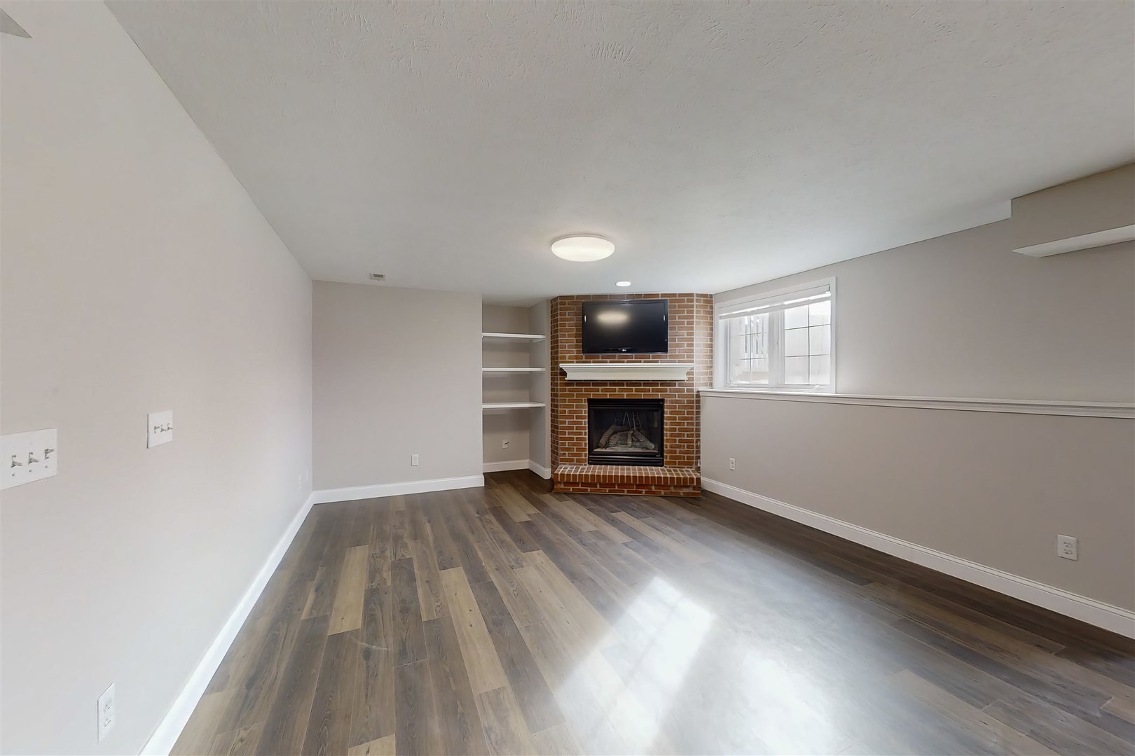 4 Cloverhill Circle Bloomington, IL 61705 - Photo 60 of 63 an empty room with wooden floor fireplace and windows