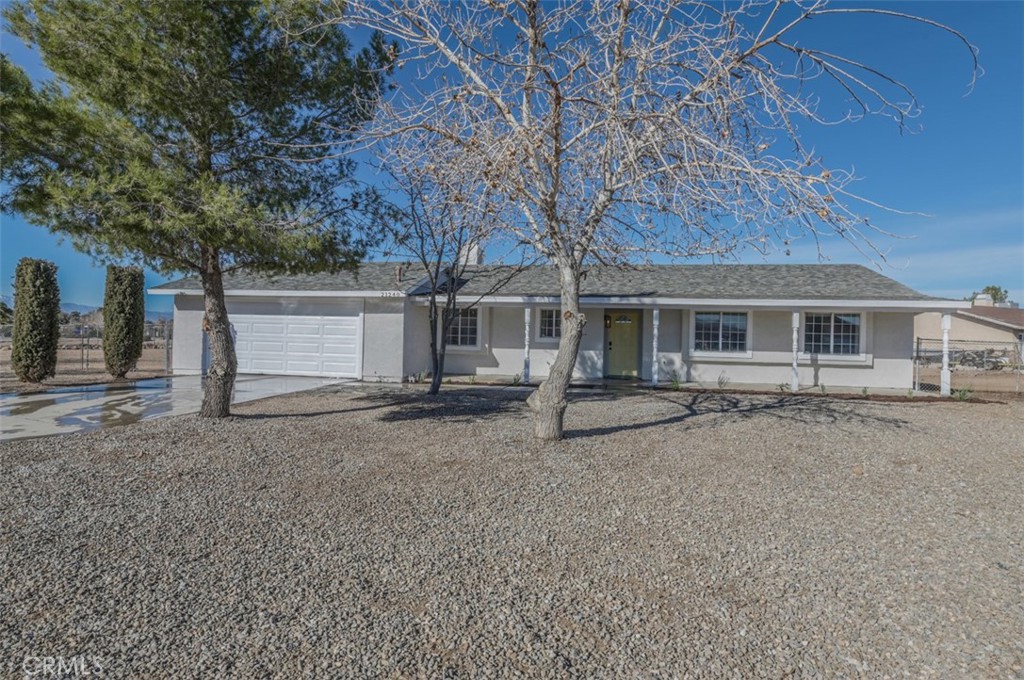 21240 Neola Road Apple Valley, CA 92308 - Photo 1 of 1 front view of a house with two trees and garage